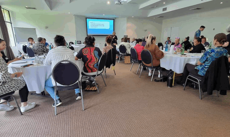 Groups of people seated around tables for a workshop.